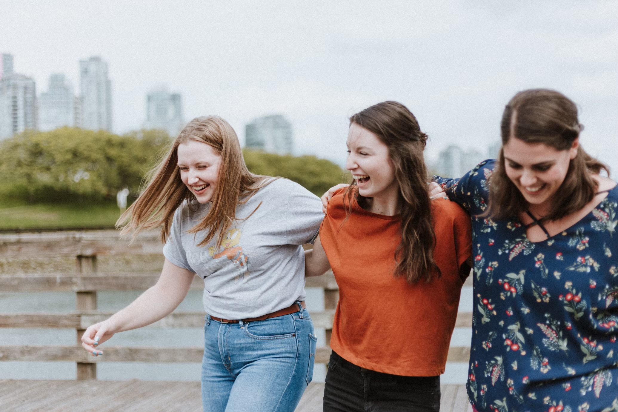 Three women smiling, laughing together