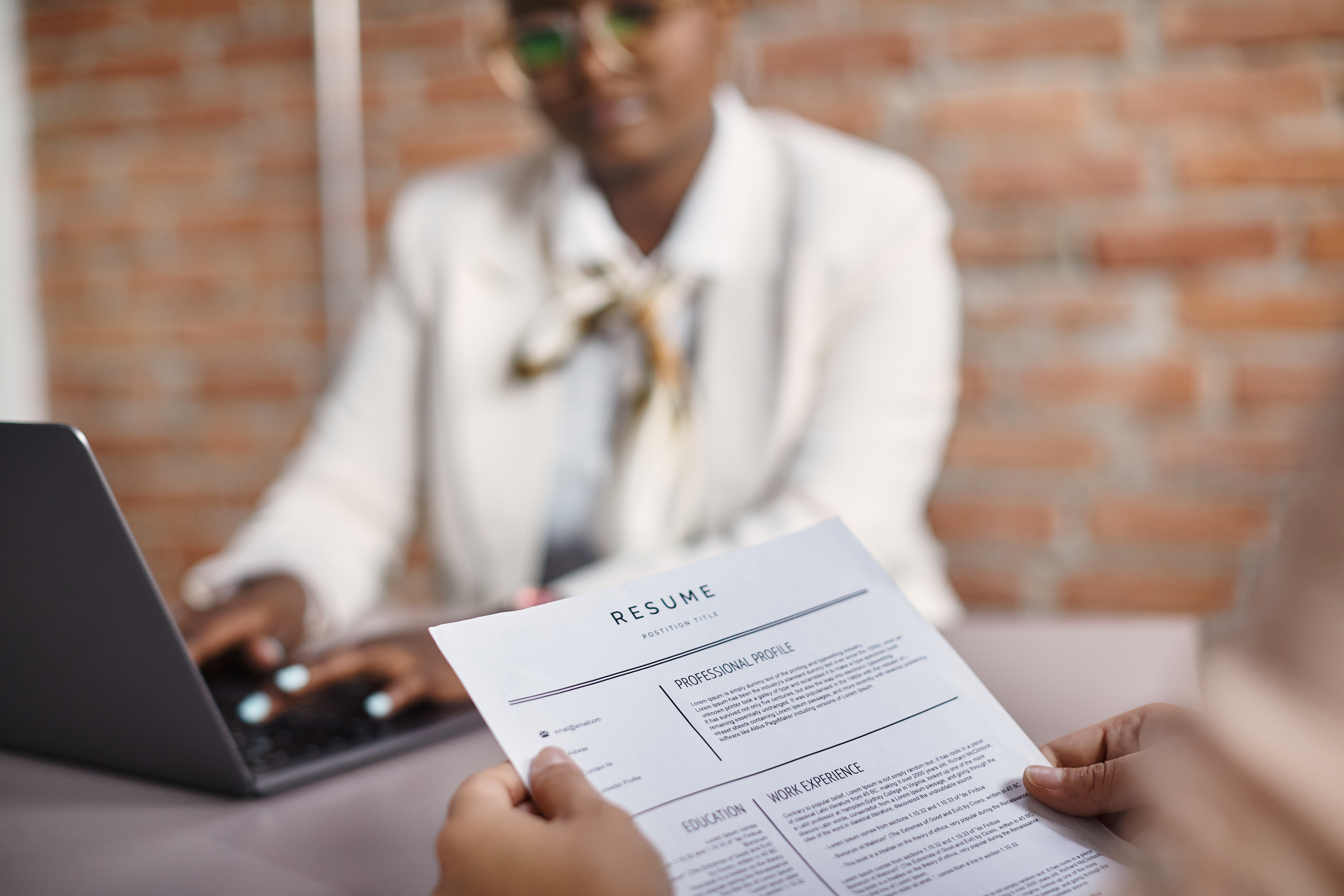close up of person holding a resume in a job interview
