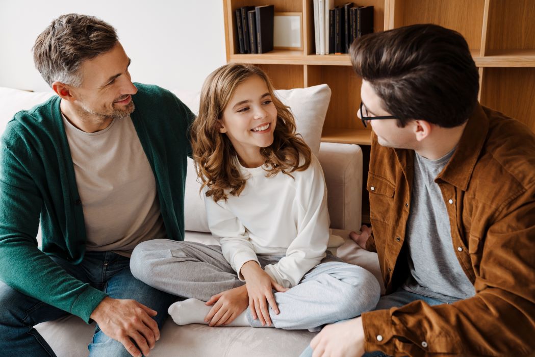 happy male couple talking to their daughter