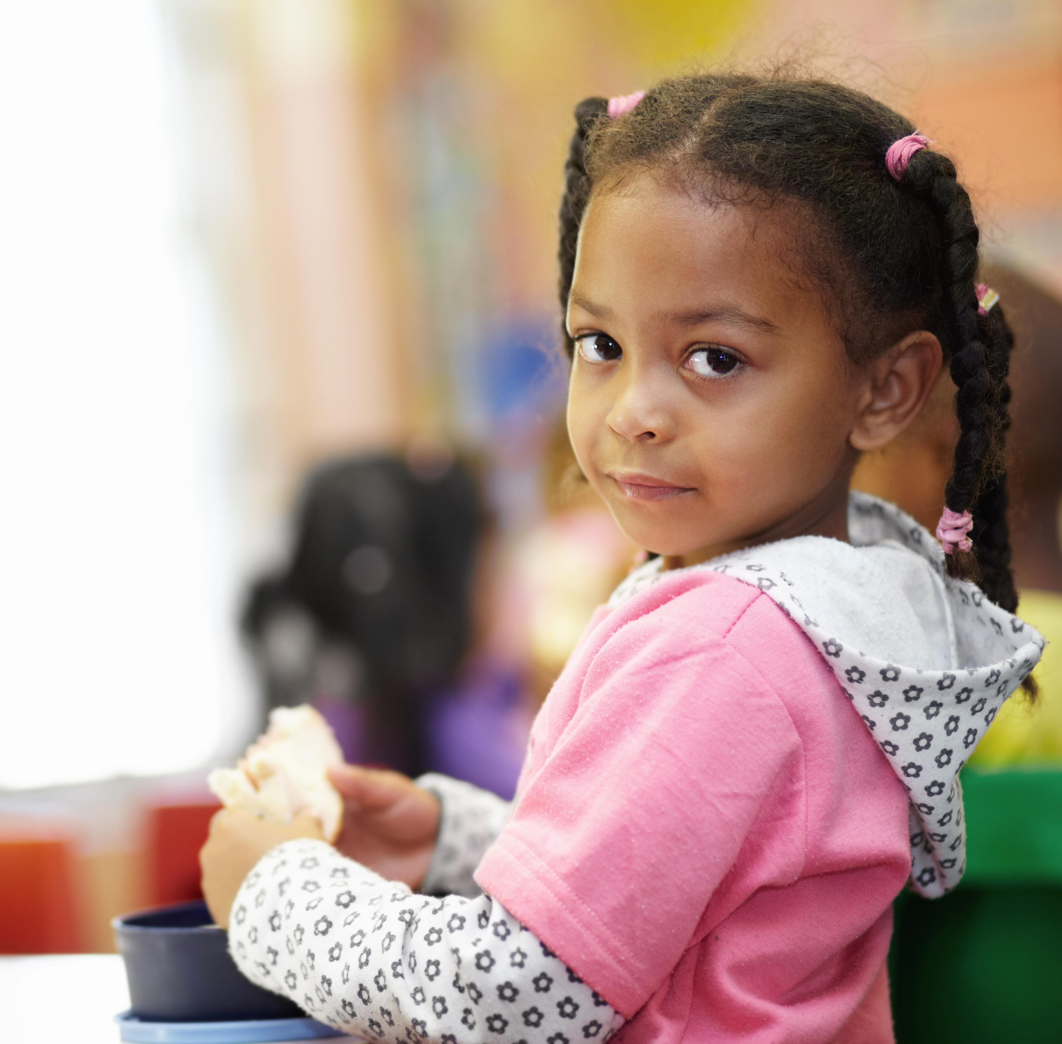 little girl eating a sandwhich