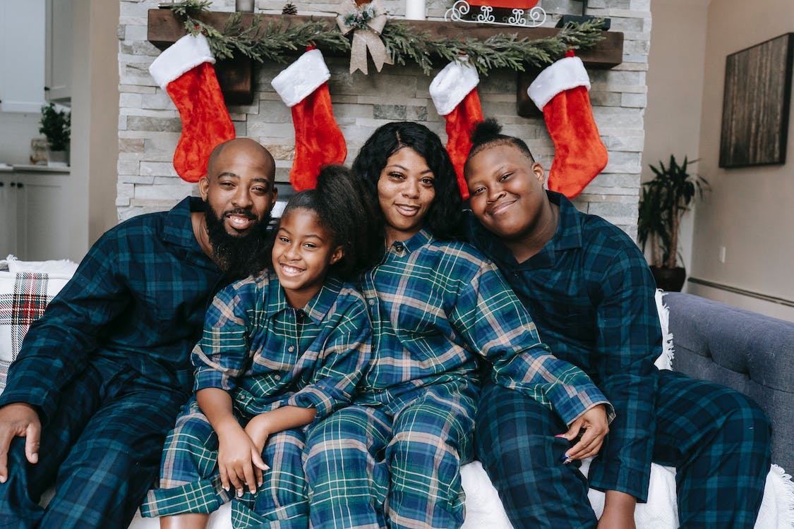 A family posing in front of a fireplace