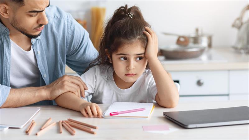 father helping daughter with homework