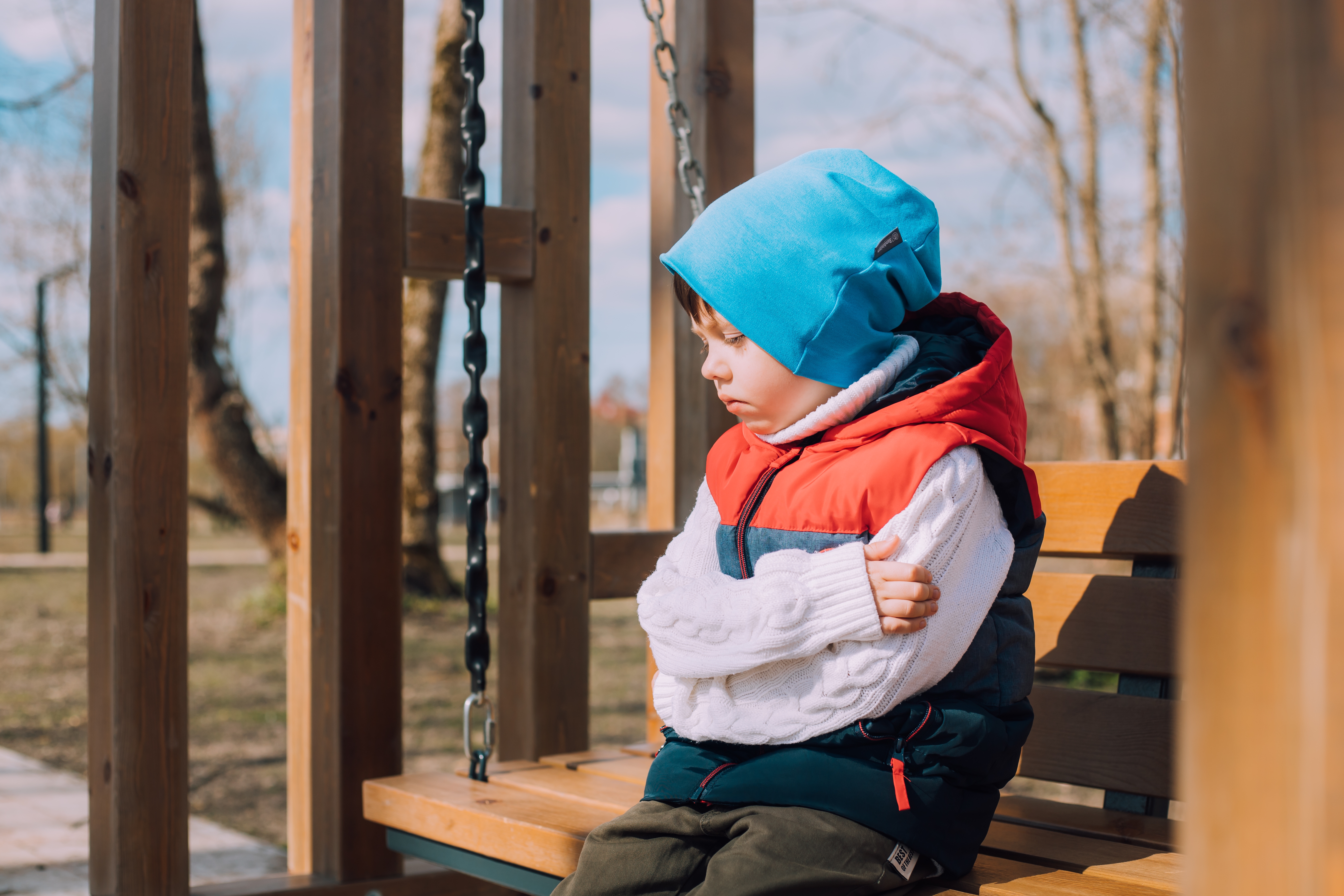 sad child sitting on a bench