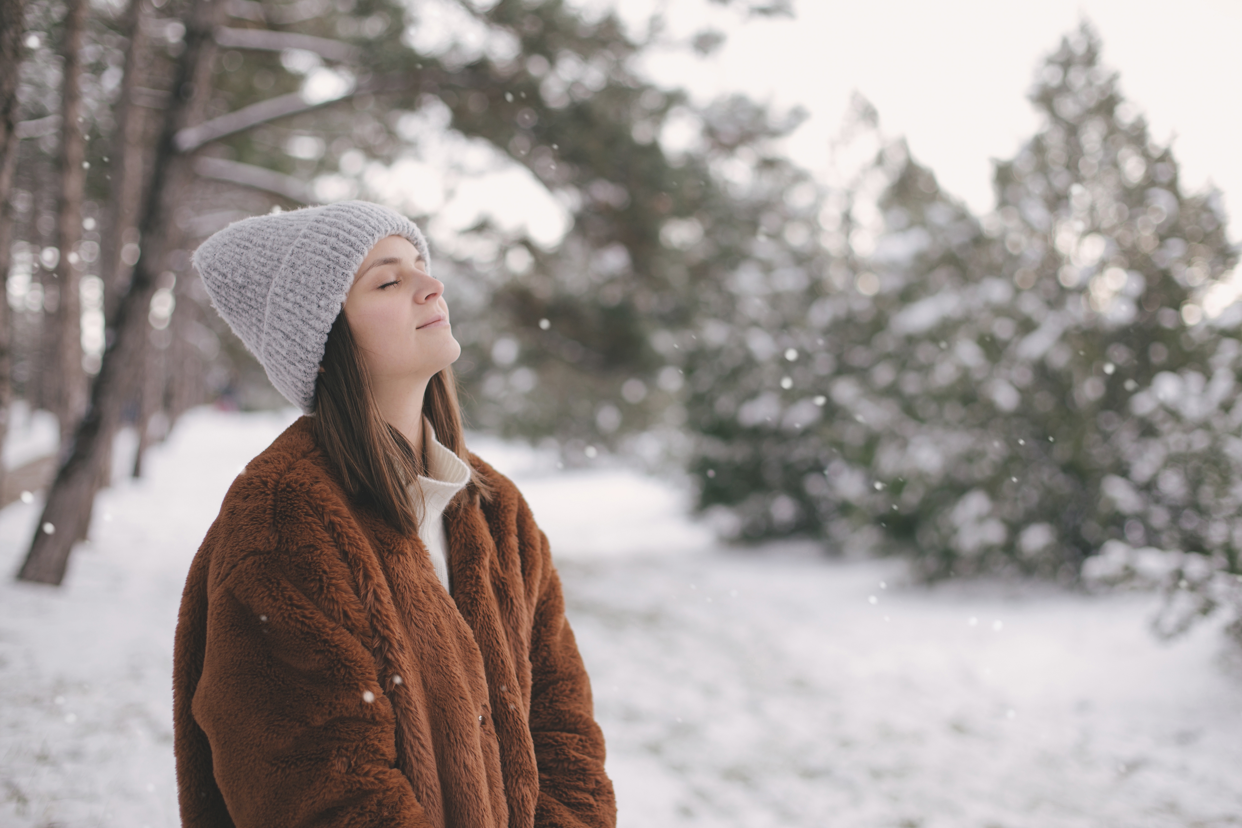 woman wearing winter gear, outside in the snow